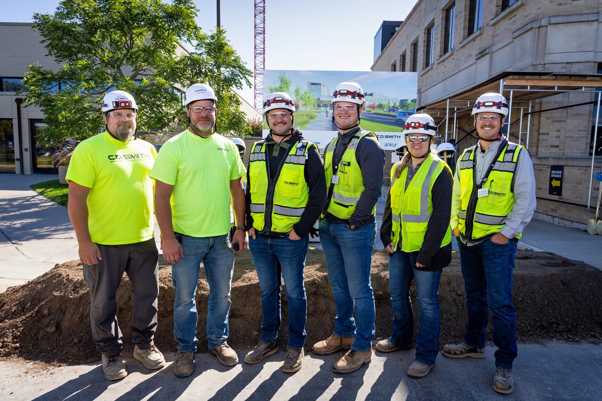 C.D. Smith project team in hard hats and high visibility gear at the HSHS St. Mary's inpatient tower site in Green Bay.
