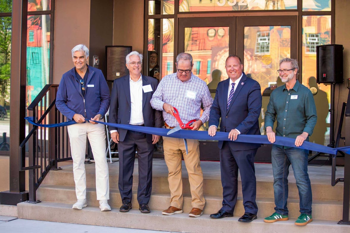 Community leaders and project partners participate in the ribbon cutting ceremony for Karrick in the Kenosha Harbor District redevelopment area.