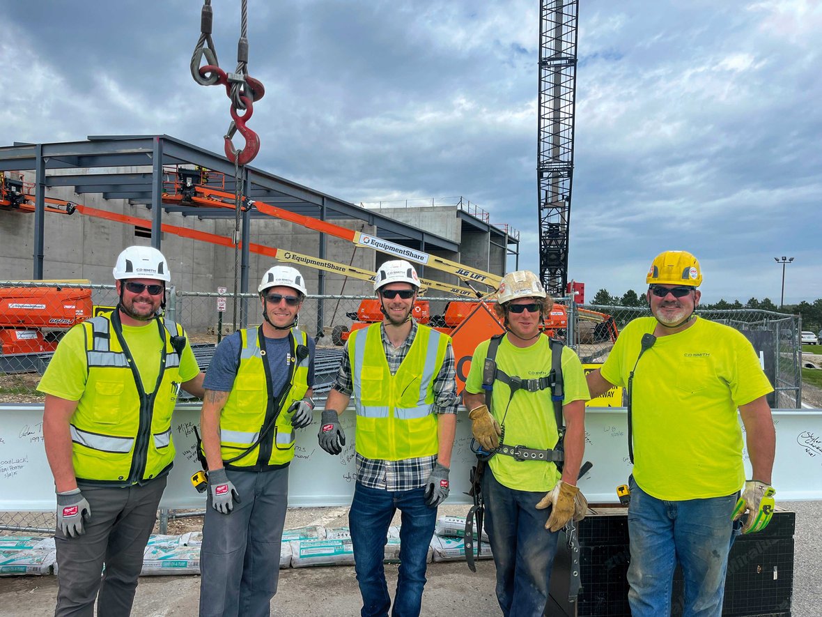 C.D. Smith Construction team members gather at the MilliporeSigma project following the final beam signing and placement ceremony, a major construction milestone.
