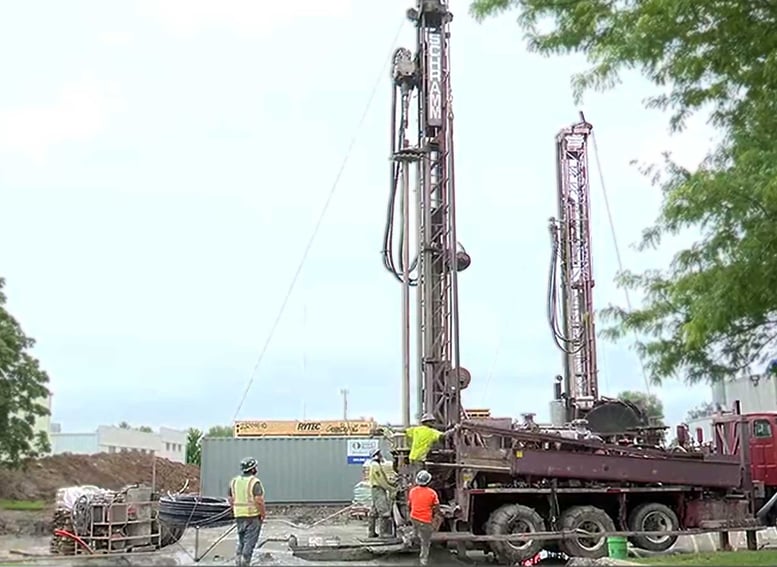 Nature’s Way geothermal project construction site with construction workers and drilling rig in Green Bay Wisconsin