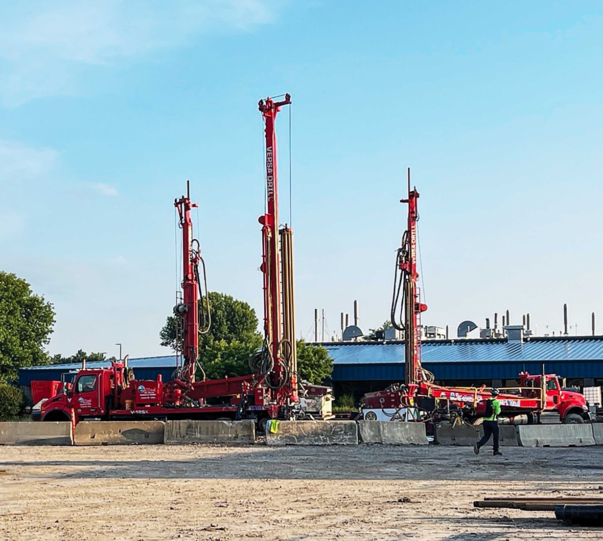 Three geothermal drilling rigs operating at the Nature's Way commercial geothermal construction project site in Green Bay, Wisconsin.