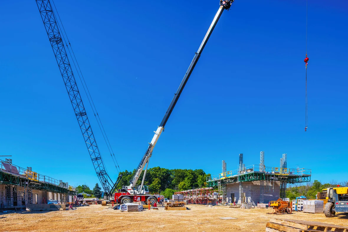 Active construction of the Port Washington Public Safety Building with cranes and structural work underway