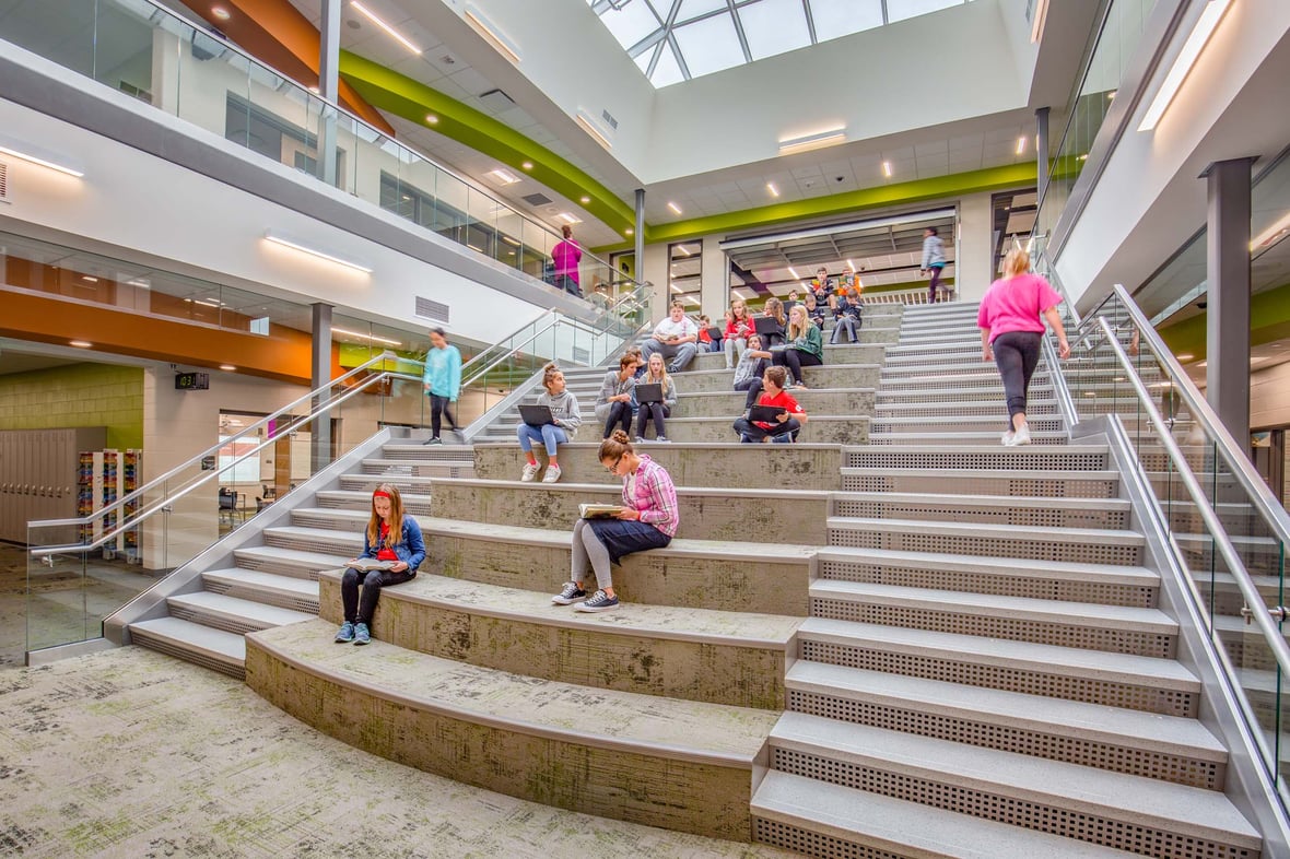 Students using a flexible learning stair space in a modern Wisconsin high school built after a referendum.