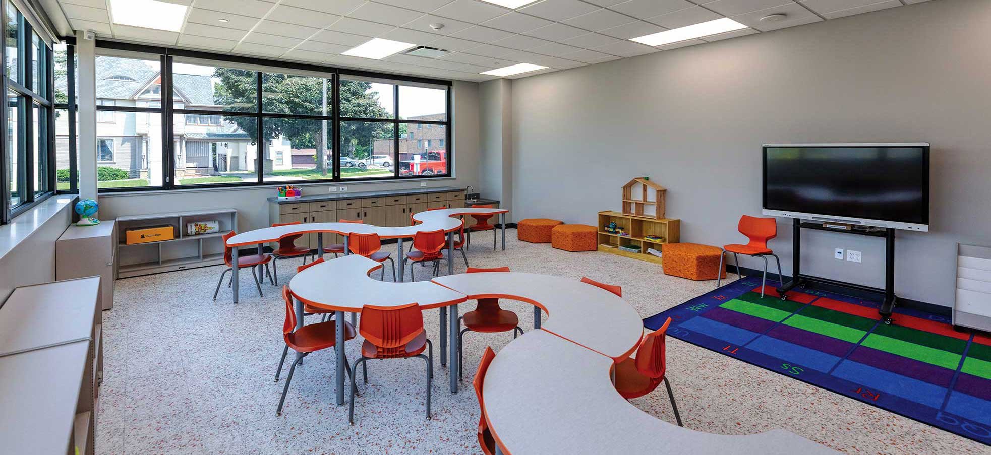 Licensed childcare classroom at Boys & Girls Club in Ripon WI with curved learning tables large windows and early education activity area