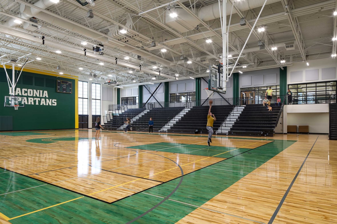 Student shoots a basket in the Laconia Spartans gymnasium at Laconia Middle and High School.