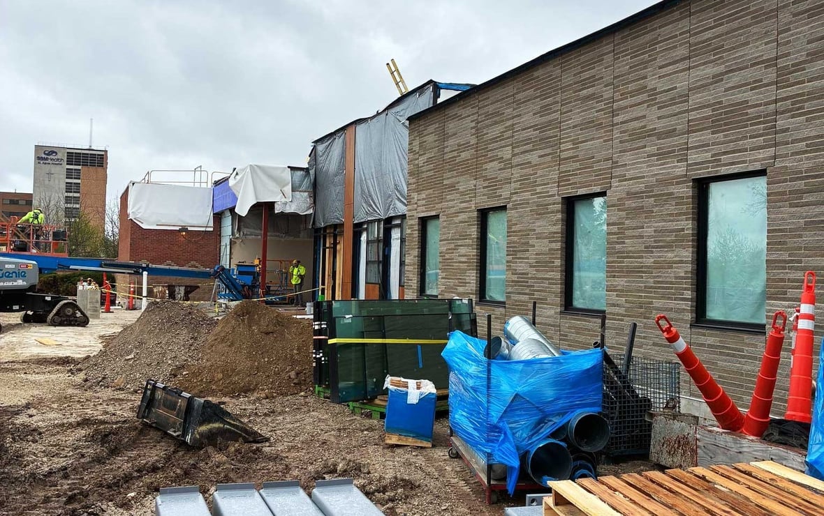 New brick facade installation nearing completion on the SSM Health Cancer Care expansion with structural steel staged in the foreground in Fond du Lac.