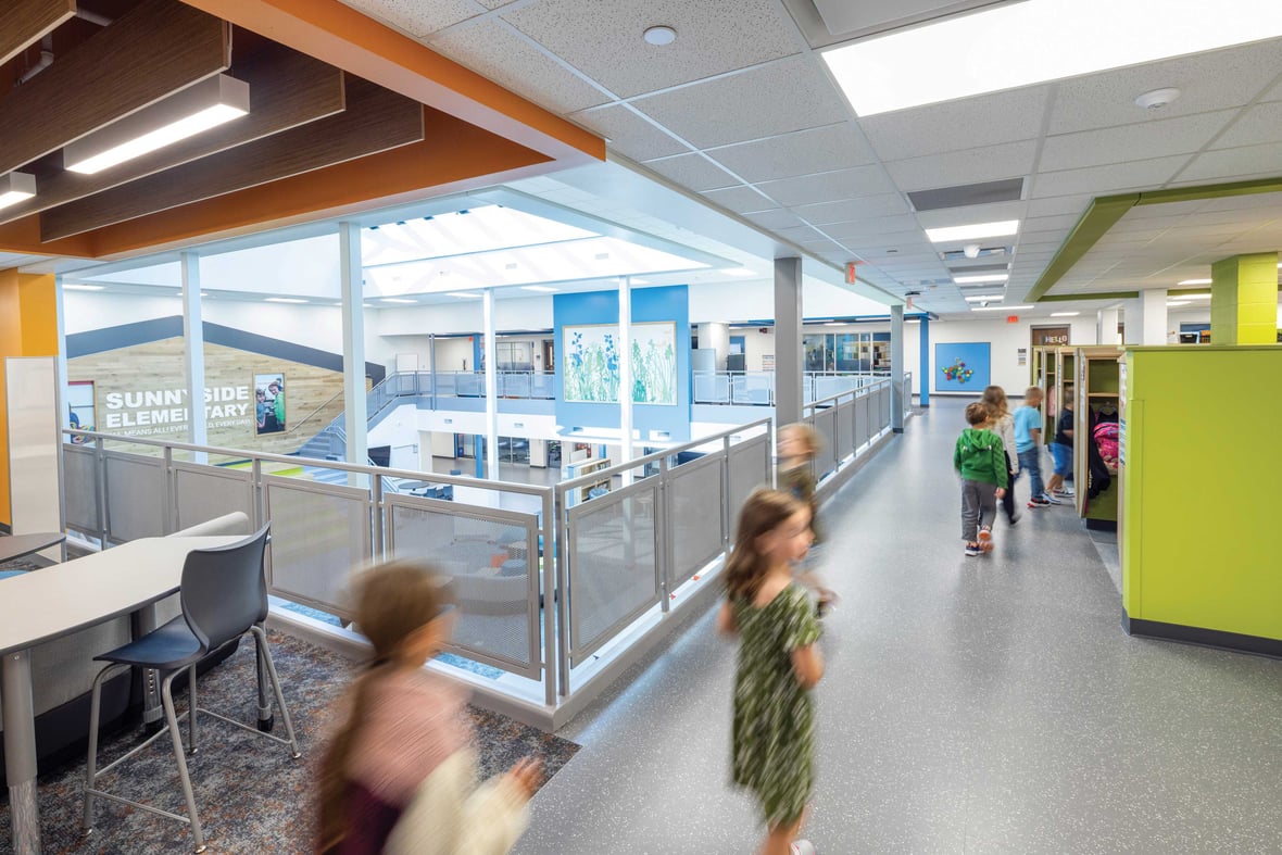 Upper-level learning corridor at Sunnyside Elementary School overlooking collaborative spaces filled with natural light